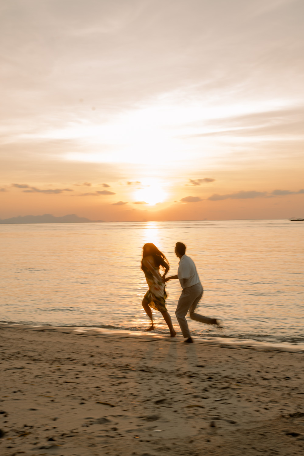 Couple walking after their Phuket ceremony, shot with a long lens