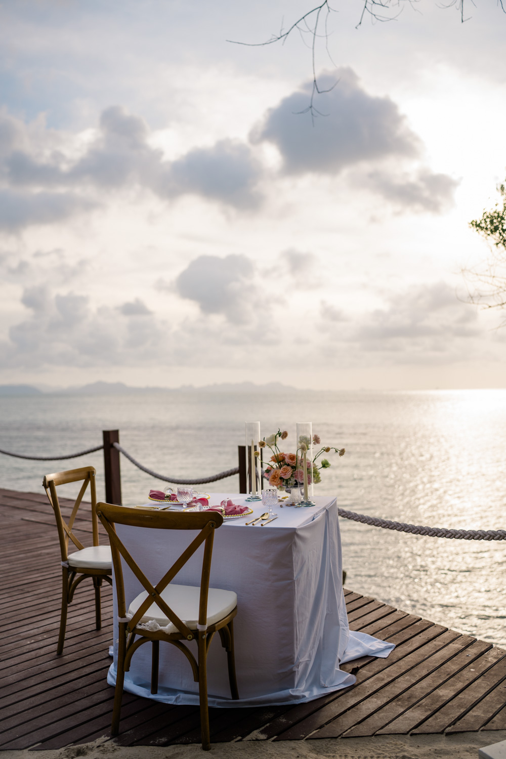 Table set for two on a seaside deck at a Koh Samui wedding